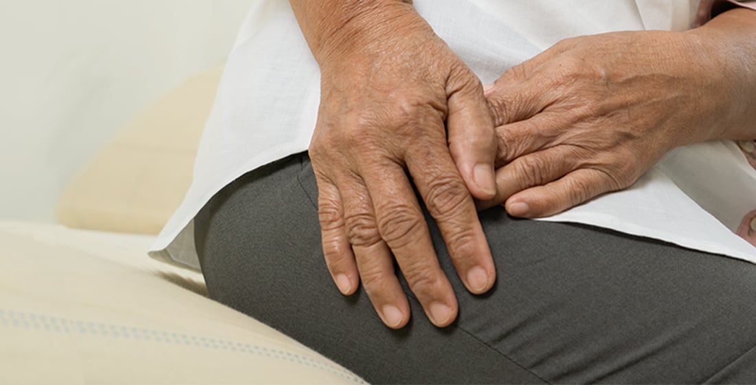 elderly woman holding hip in pain