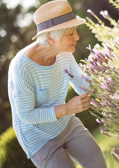 elderly-woman-smelling-flowers-2